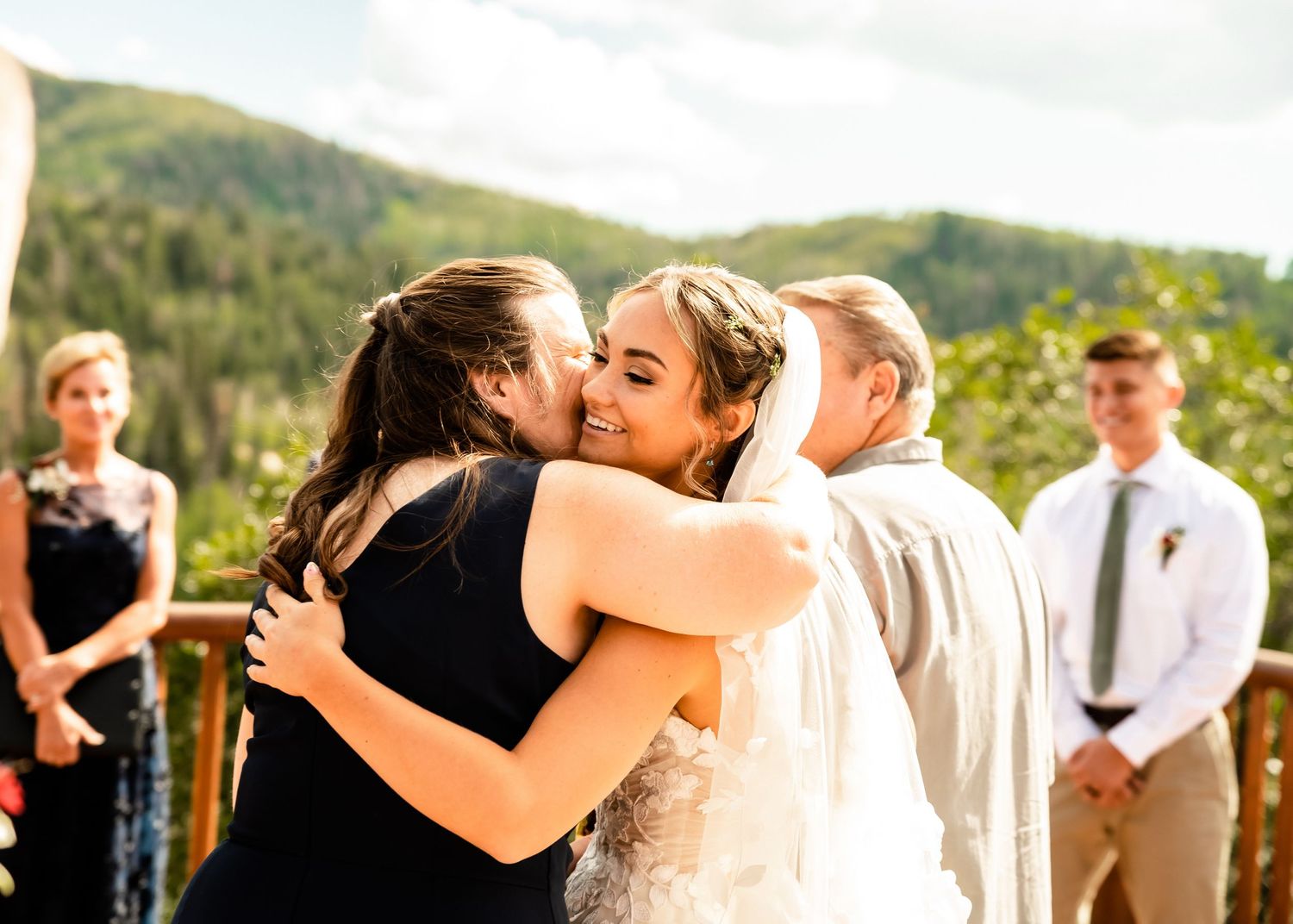 Wedding ceremony moments captured against mountain backdrop.