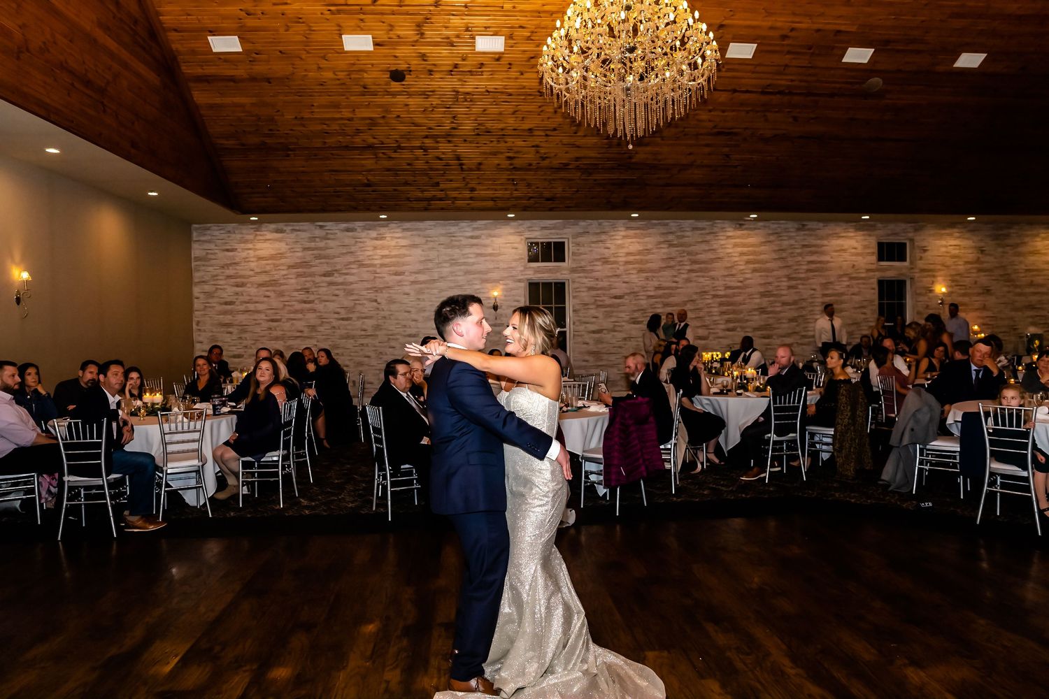Elegant ballroom dance scene with chandeliers and romantic lighting.