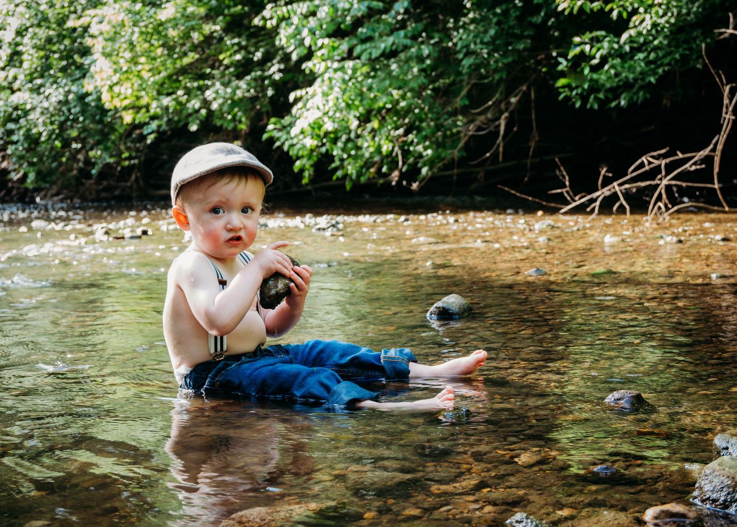 Young boy playing in the creek during a creek stomp session