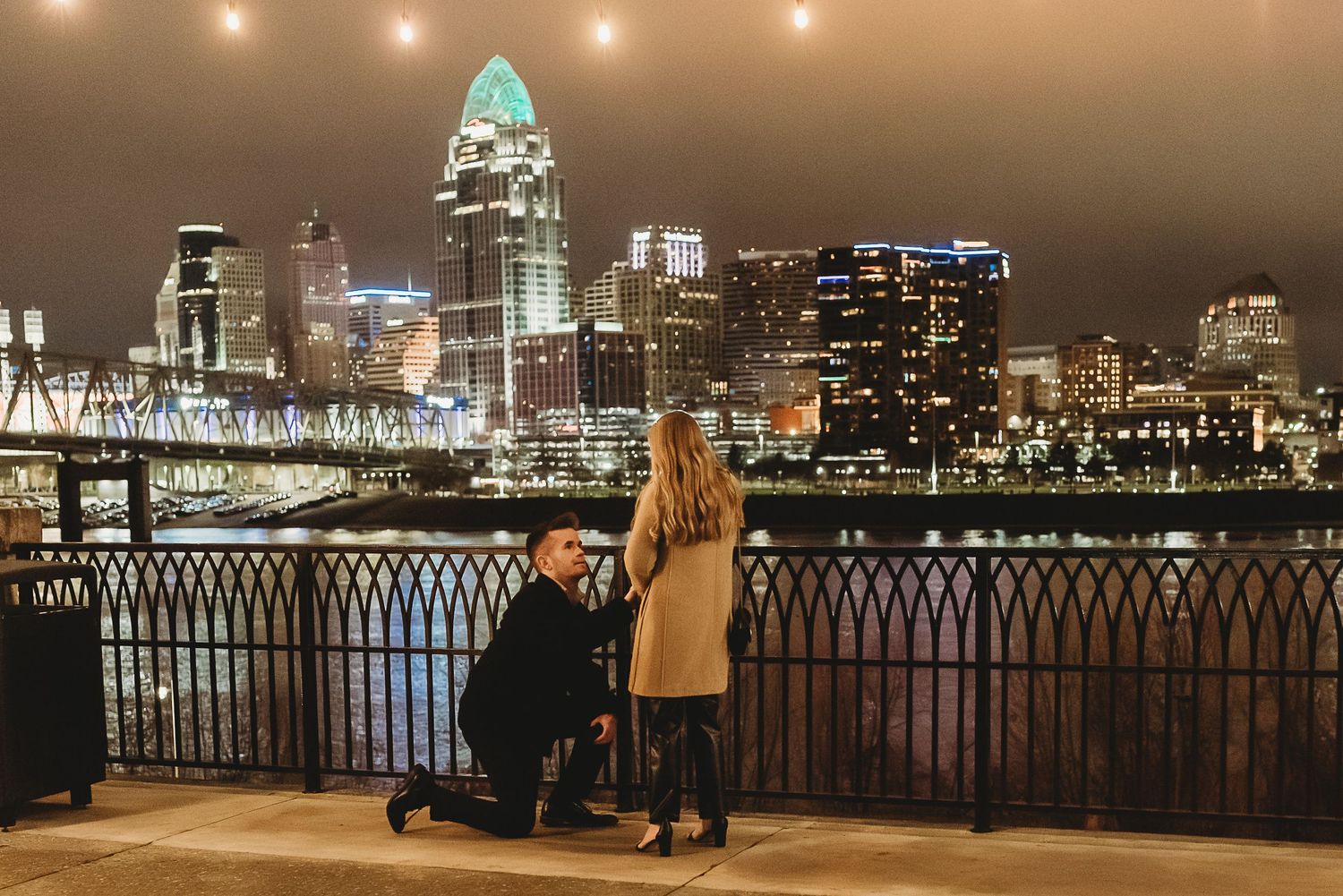 beautiful couple gets engaged in downtown cincinnati at night