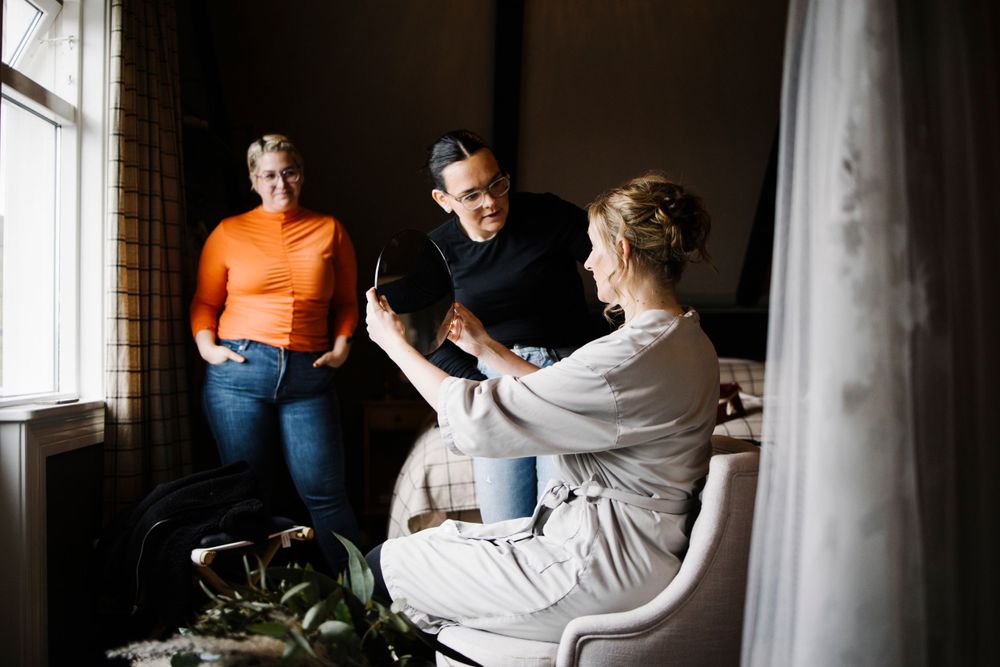 Candid indoor scene of people having a casual conversation by a window.