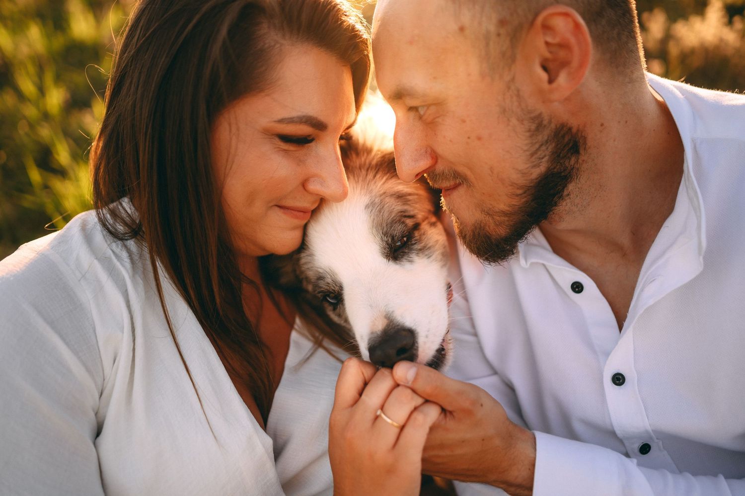Intimate romantic moment captured in golden sunlight with mountain backdrop.