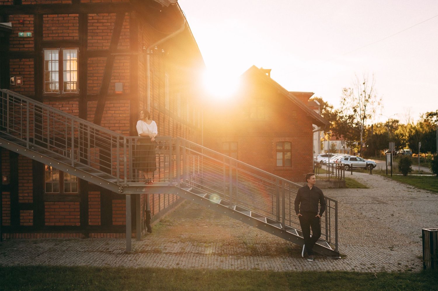 Rustic brick building exterior bathed in warm golden sunset light.