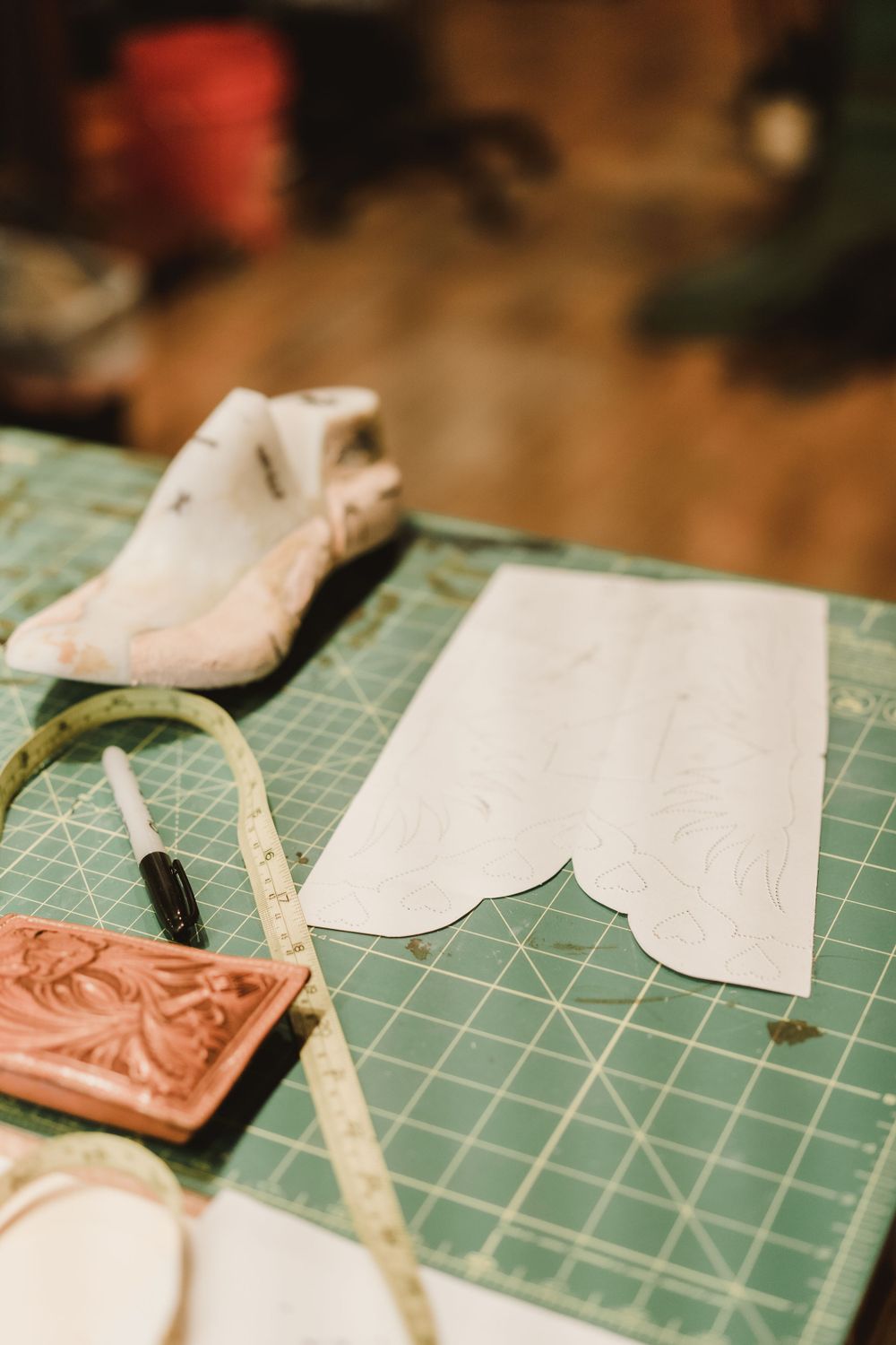 Close-up shots of leather crafting materials and tools on a green cutting mat.