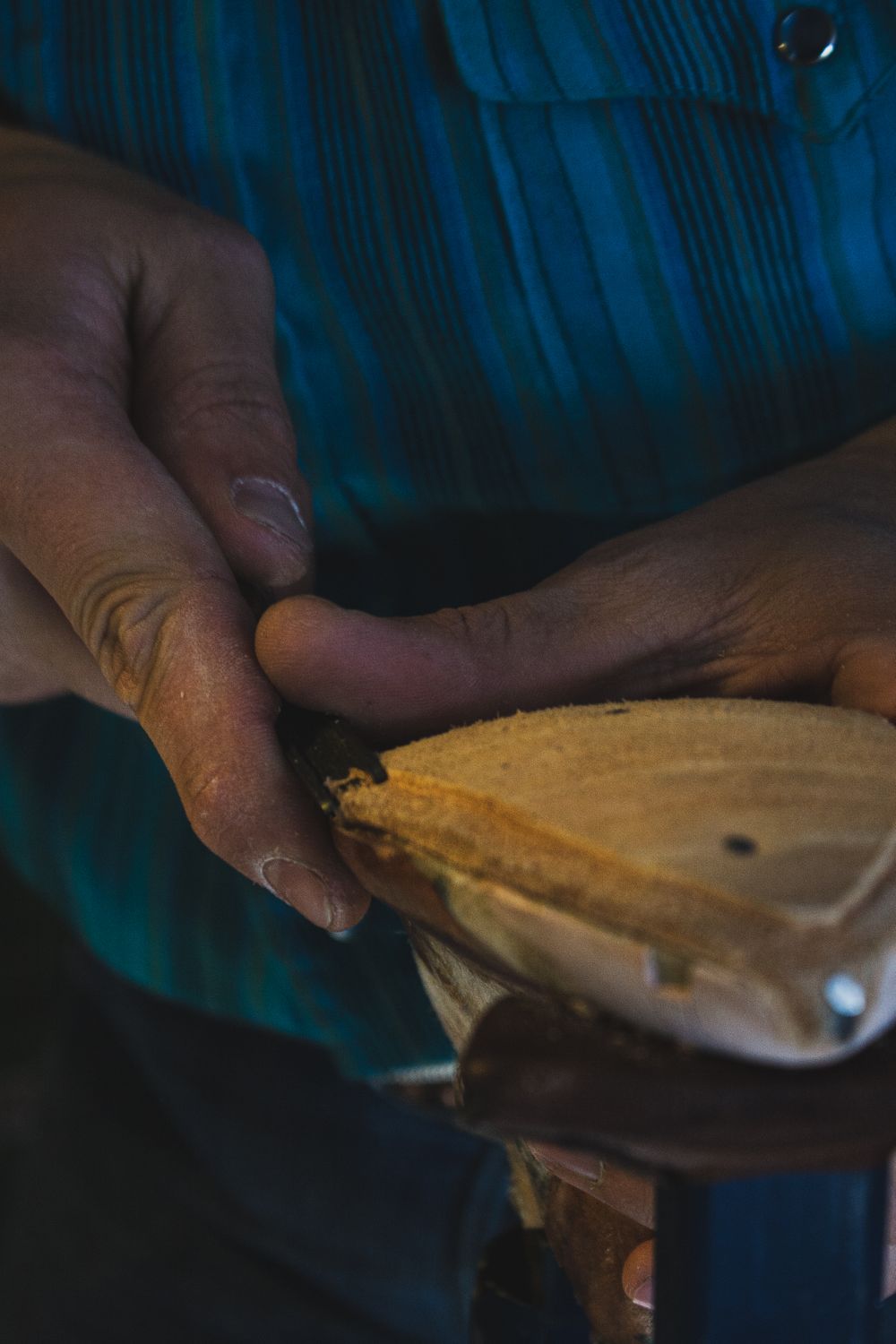 Close-up sequence of hands unwrapping a package in dark lighting conditions.