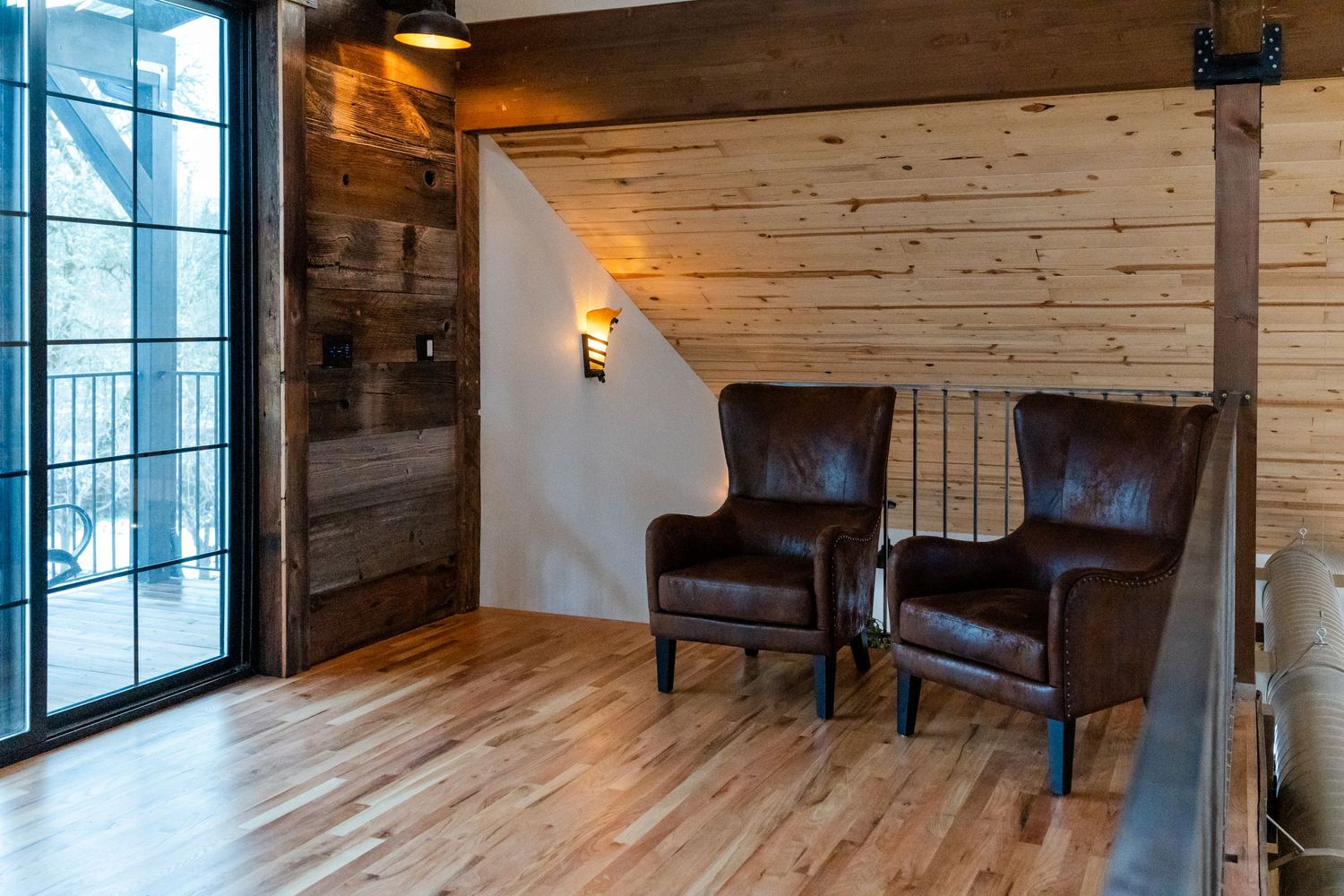 balcony with sliding door and comfy chairs