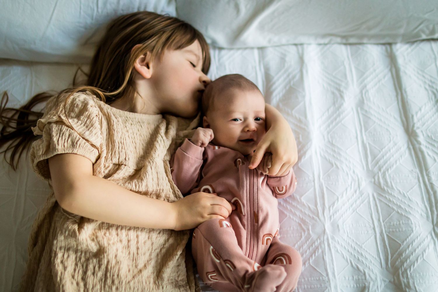 Brown & pink outfits for big sister & newborn baby sister during at-home lifestyle newborn photos in Calgary AB.