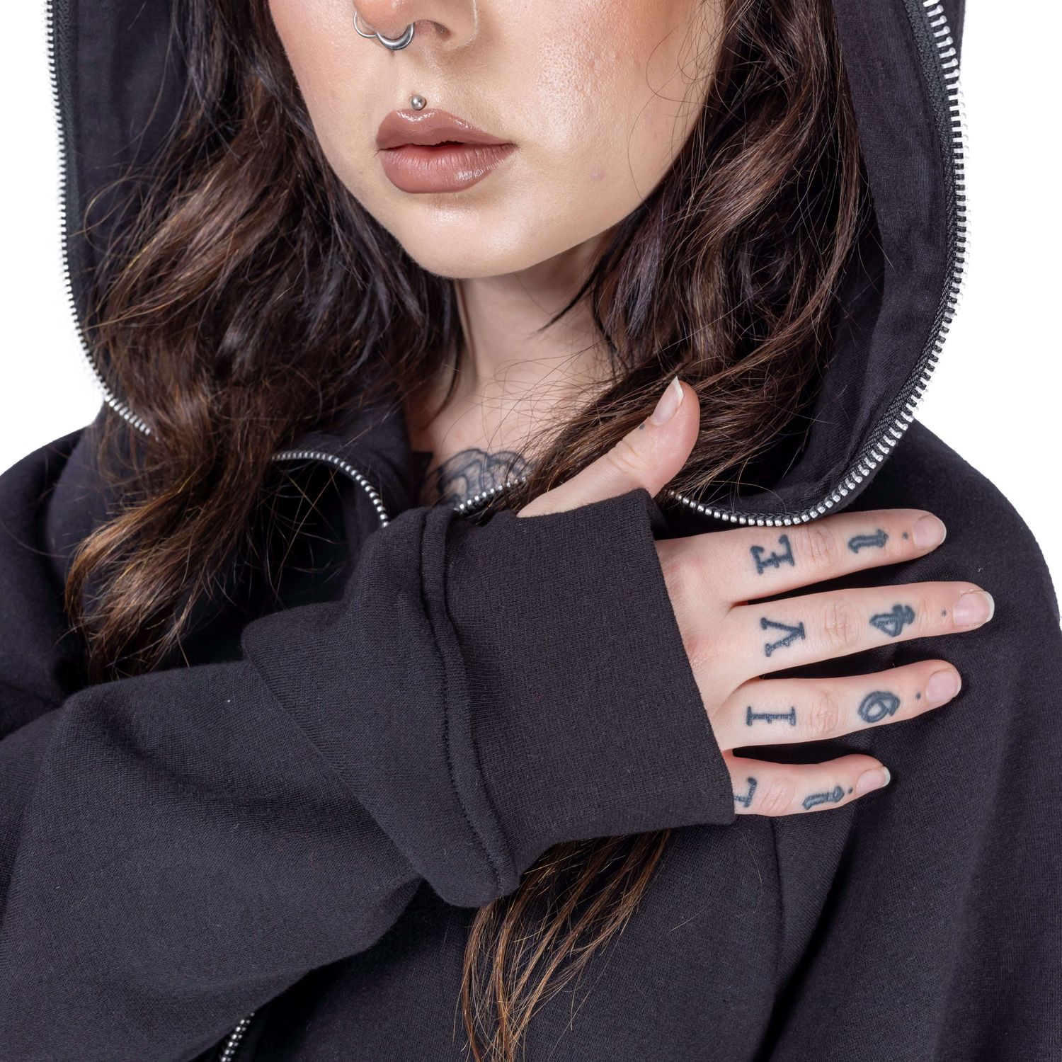 close up of model's tattooed hand in goth hoodie for Innocent Clothing in goth hoodie shot by Amy Davies in Hove