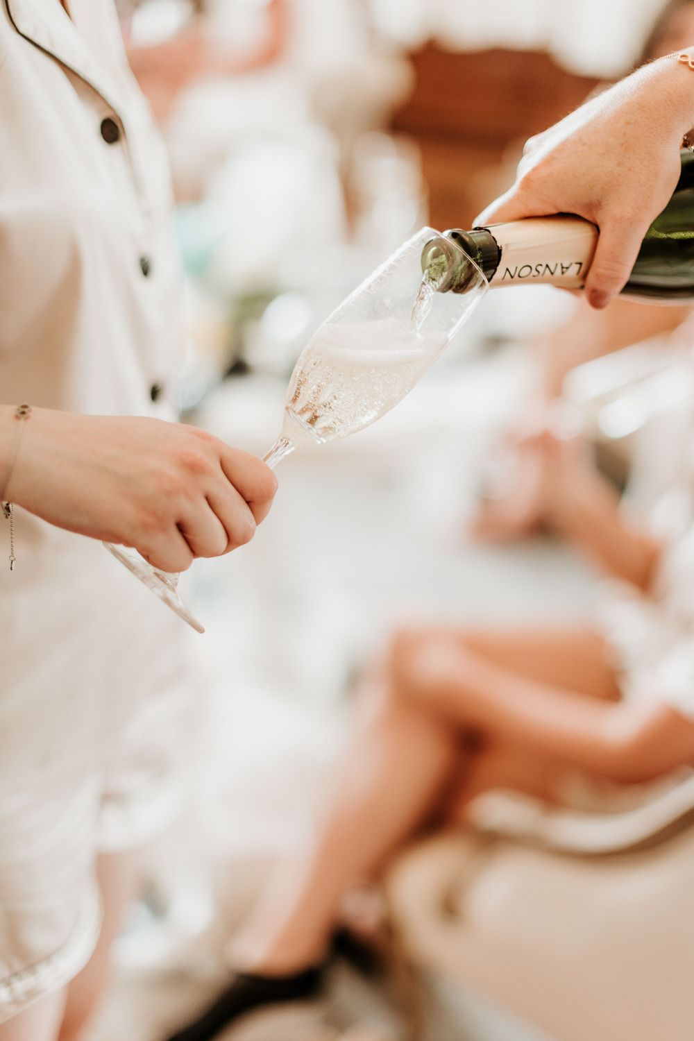 Champagne being poured into glasses during wedding celebration.