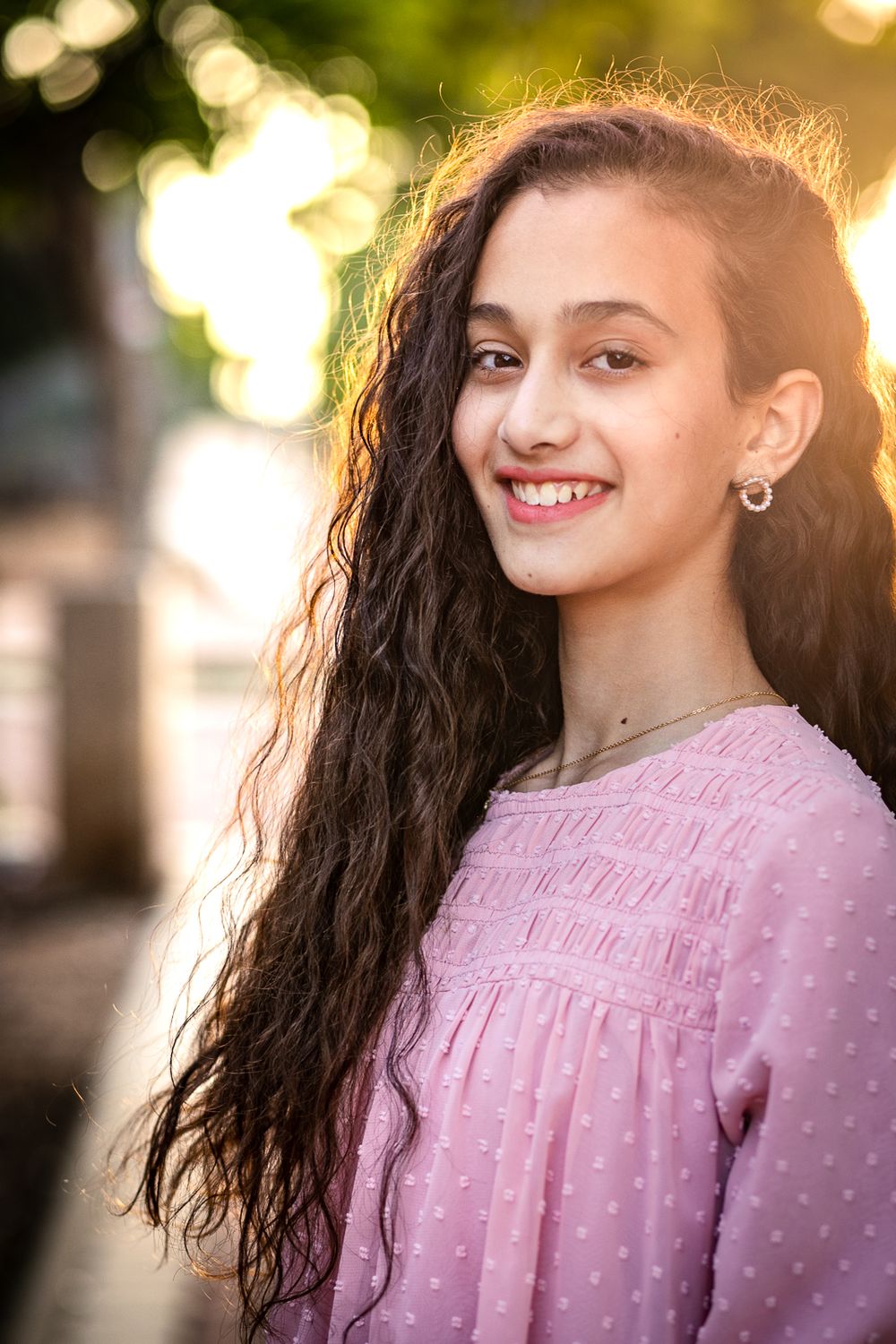 Portrait of a smiling girl and sunlight in her hair