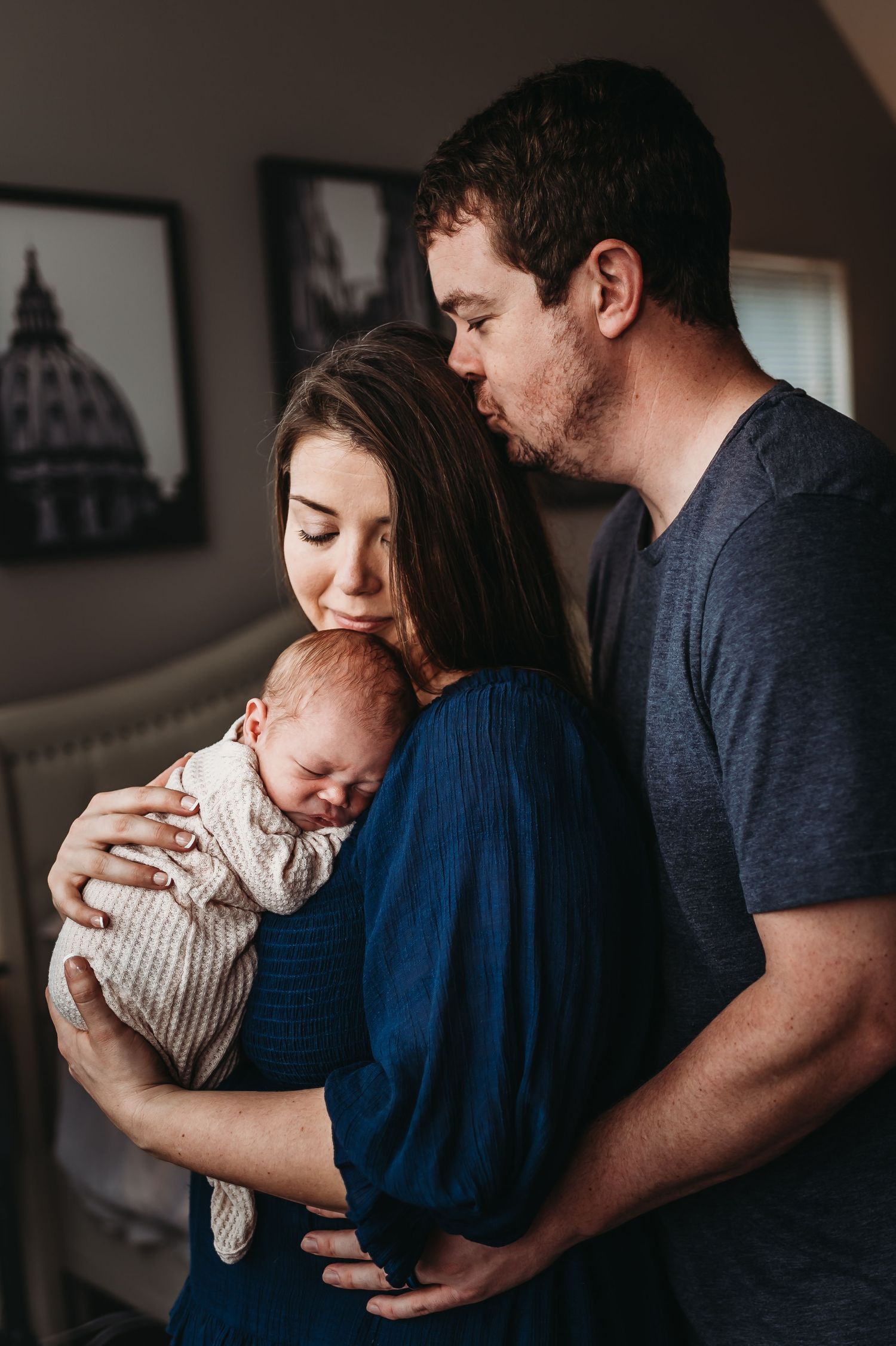 Intimate indoor family moment with newborn baby.