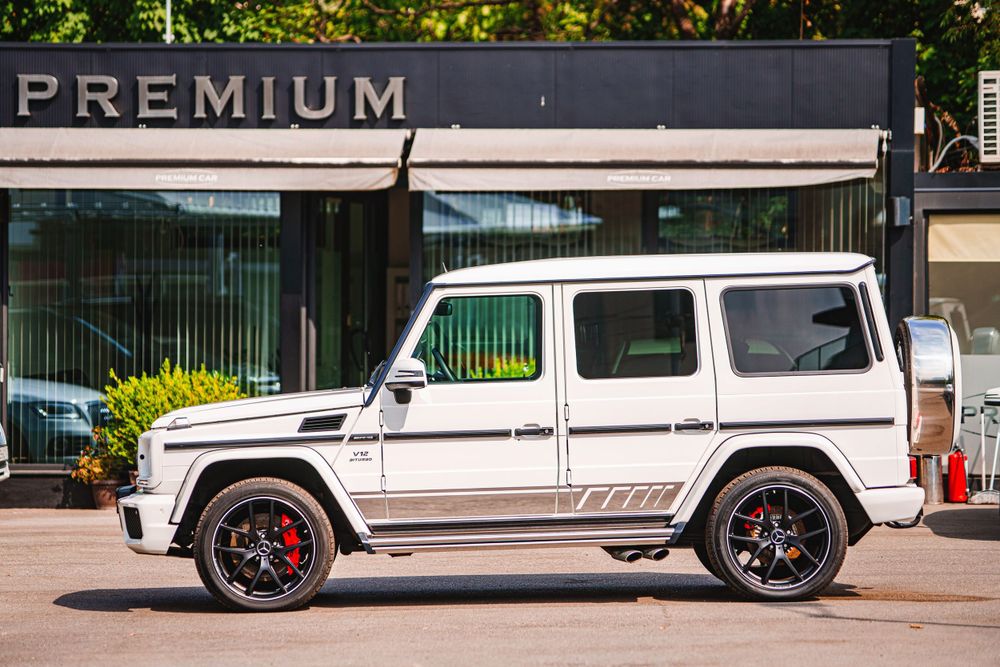 Side view of a white Mercedes G-Wagon with sport trim and red brake calipers.