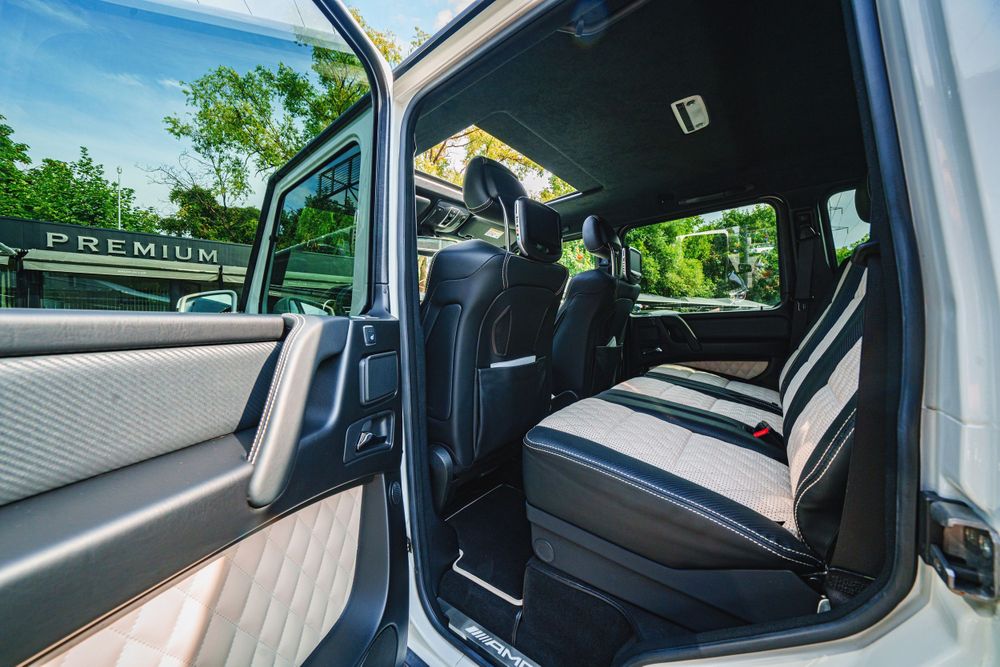 Luxurious interior of Mercedes G-Class showing spacious rear seating with quilted upholstery.