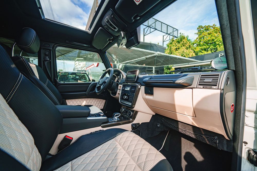 Driver's cockpit of Mercedes G-Class with beige and black interior trim.