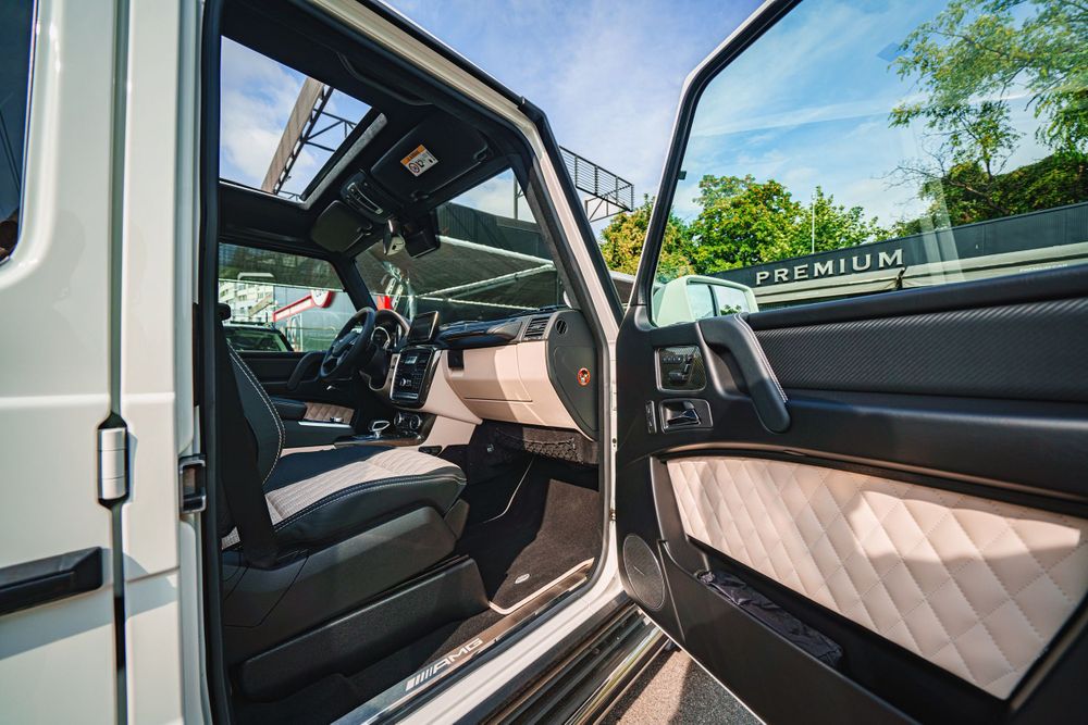 Front interior view of Mercedes G-Class showing dashboard and beige door panels.
