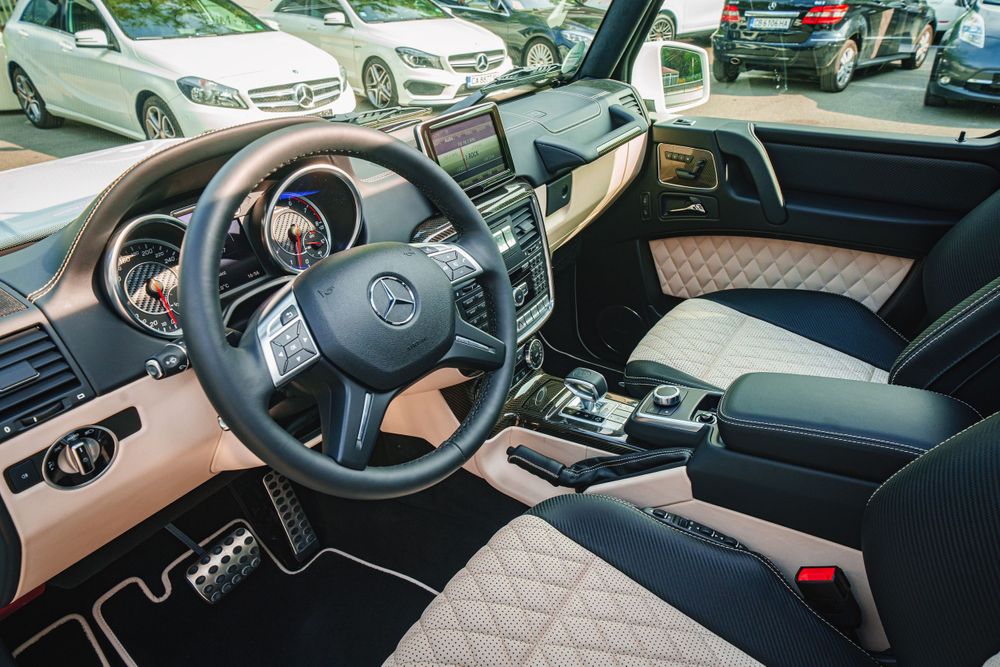Modern Mercedes interior showing luxurious dashboard and steering wheel with quilted leather seats.