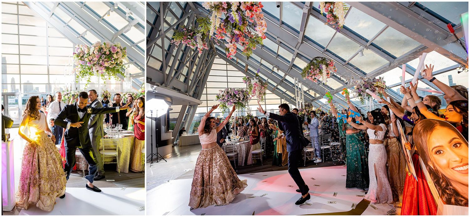 Wedding celebration with guests dancing and celebrating in a modern glass-enclosed venue.