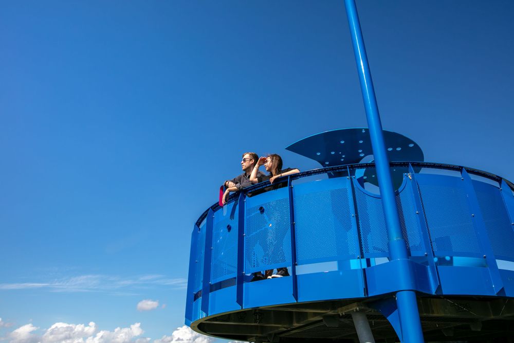 A couple looking out from a pilgrims viewpoint at Boston Lincolnshire, big blue skies on a summers day, tourism photography