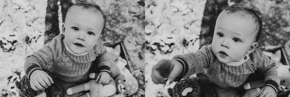 Black and white close-up portrait with knit sweater and plush toys.