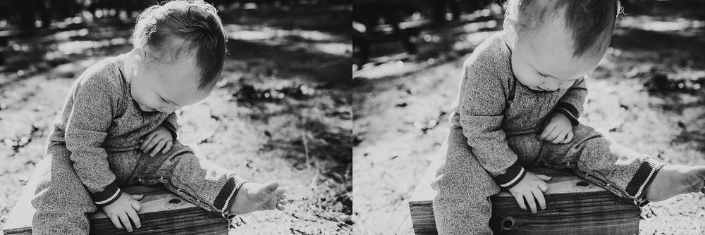 Vintage black and white photo of a child reading outdoors in dappled sunlight.