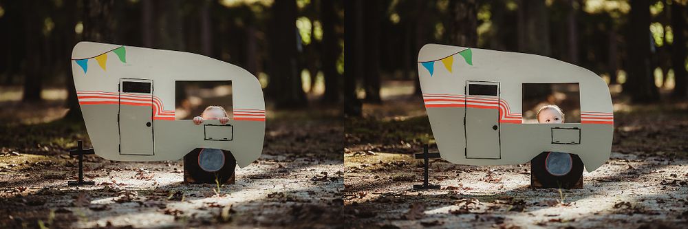 White vintage-style camper cutout with decorative details attached to tree trunk.