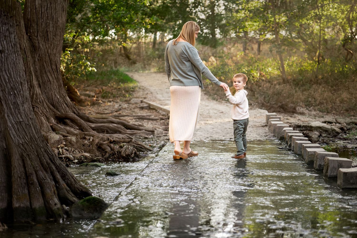 Cibolo Creek Nature Center mom and son walking in creek family photography