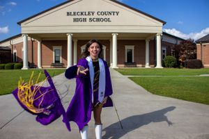 girl graduate tossing her high school cap at the camera