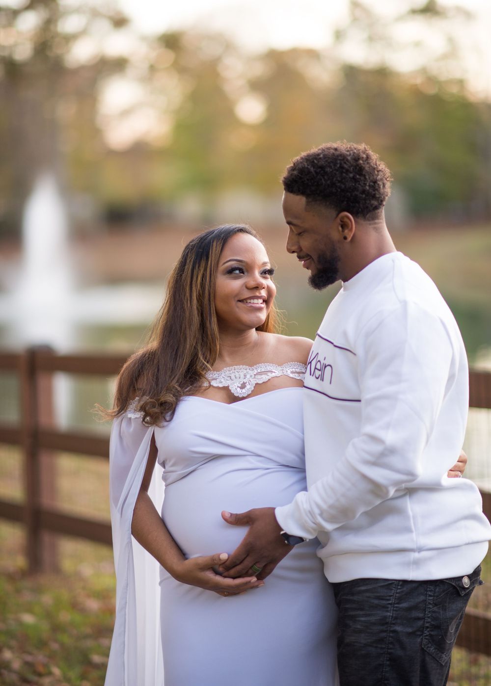 A sunset maternity session in front of the community pond.