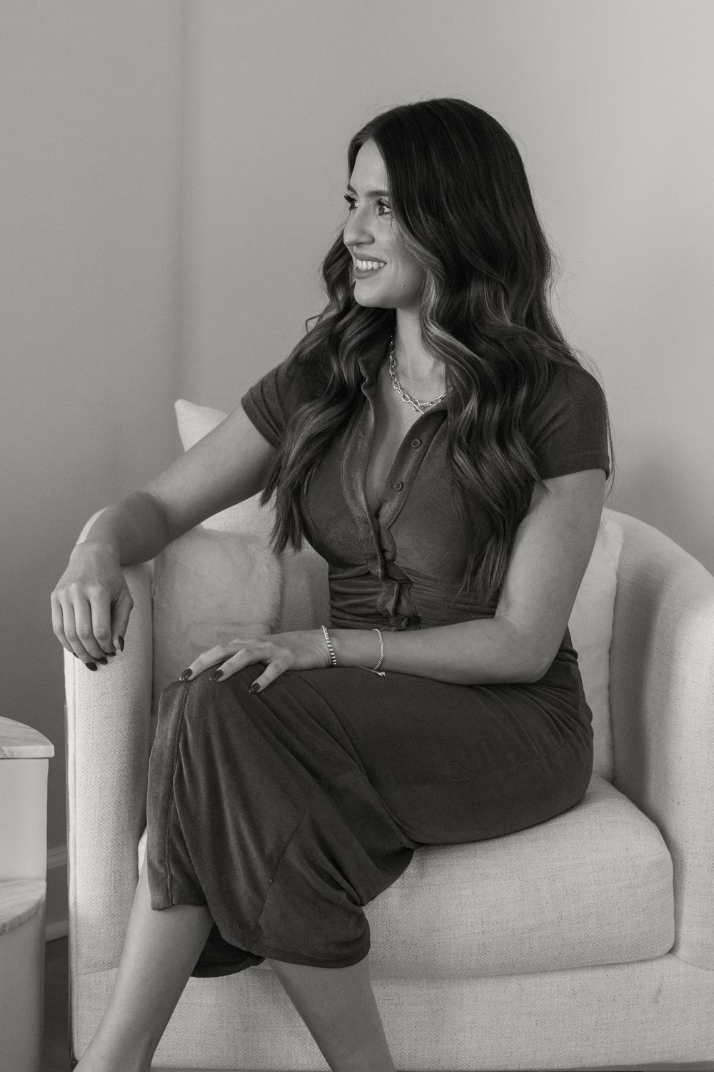 Local realtor smiling in chair during a branding photoshoot in Stuart, Florida