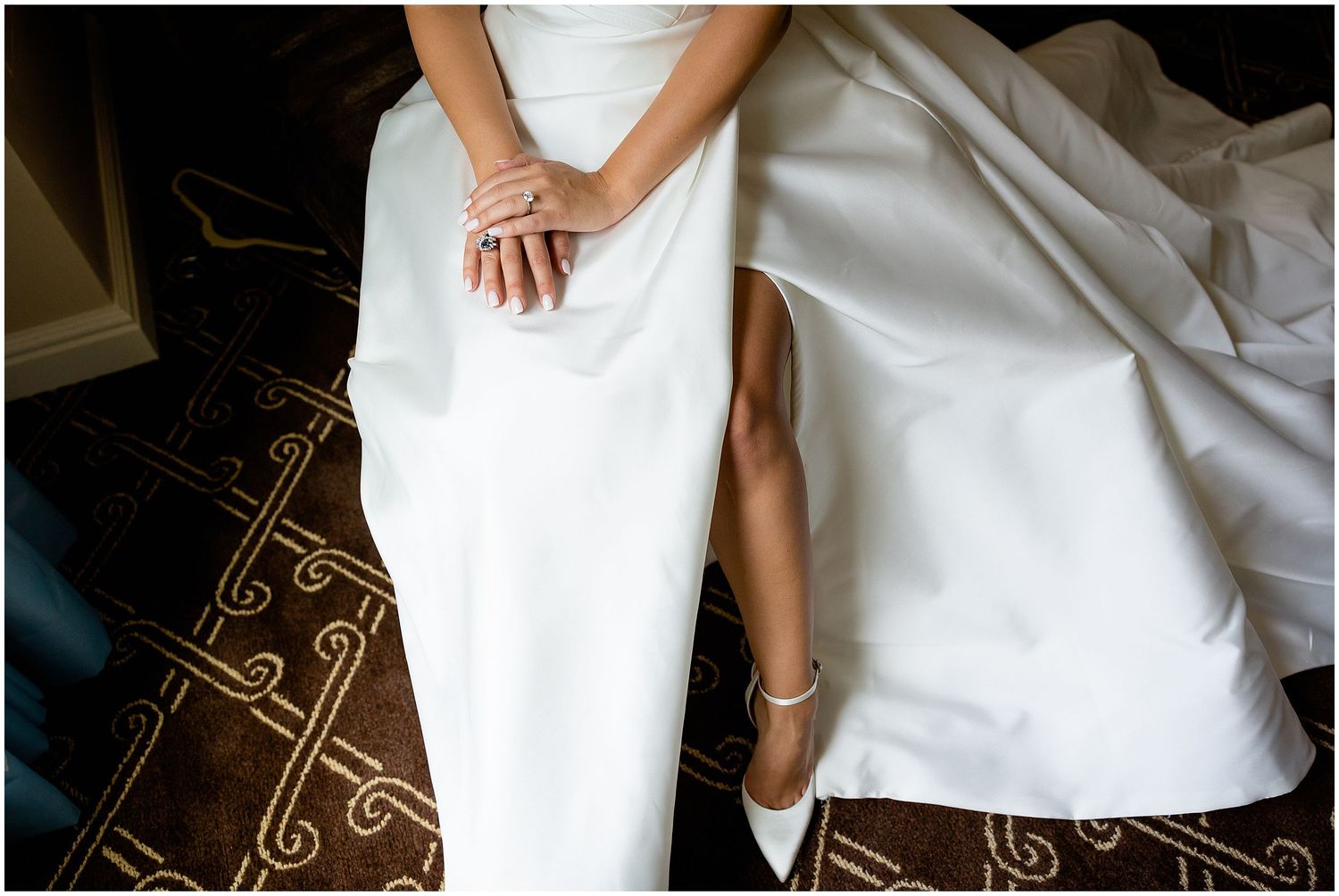 Elegant white wedding dress detail with delicate lace and fabric textures.