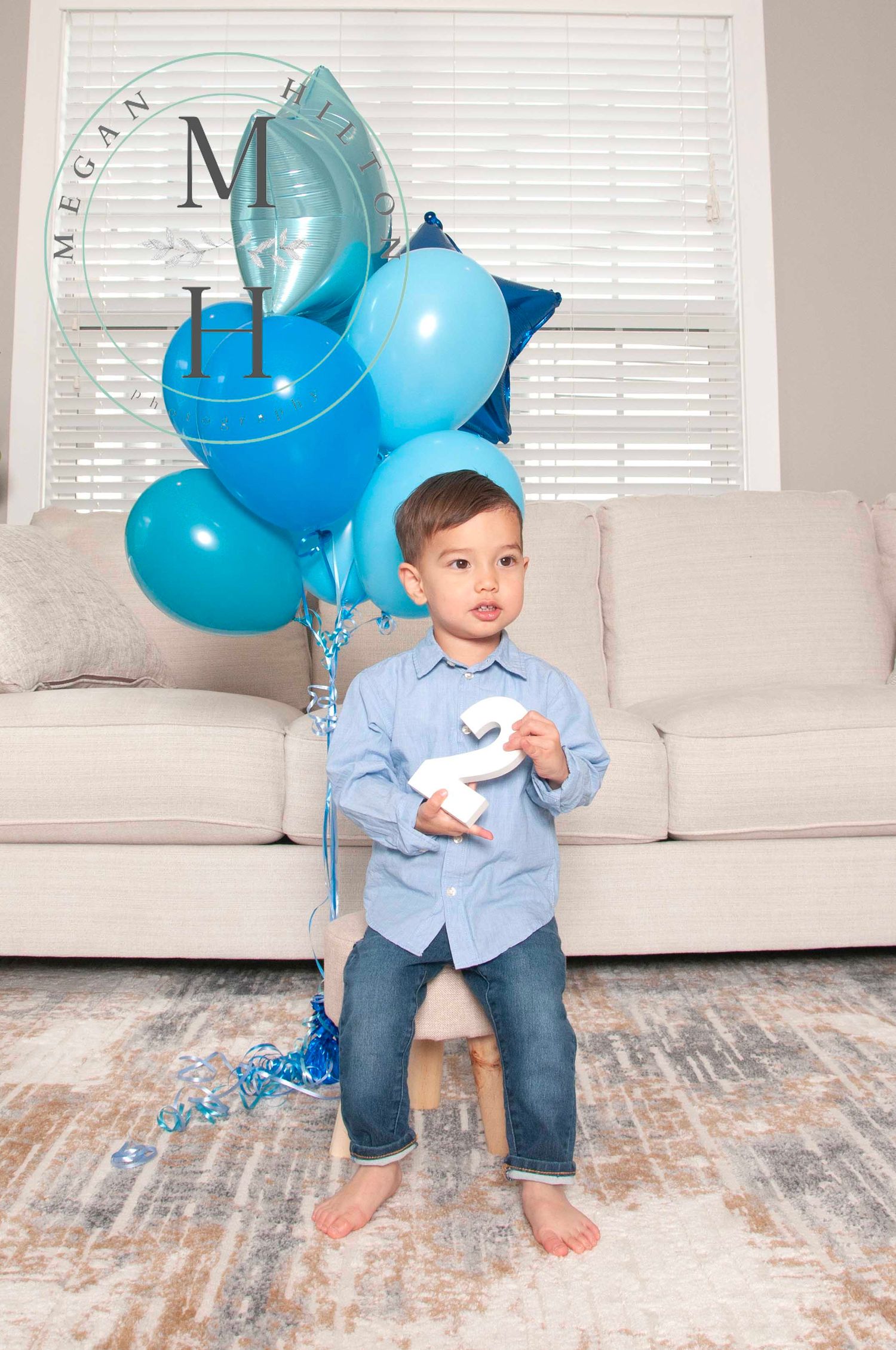Two year old boy holding number 2