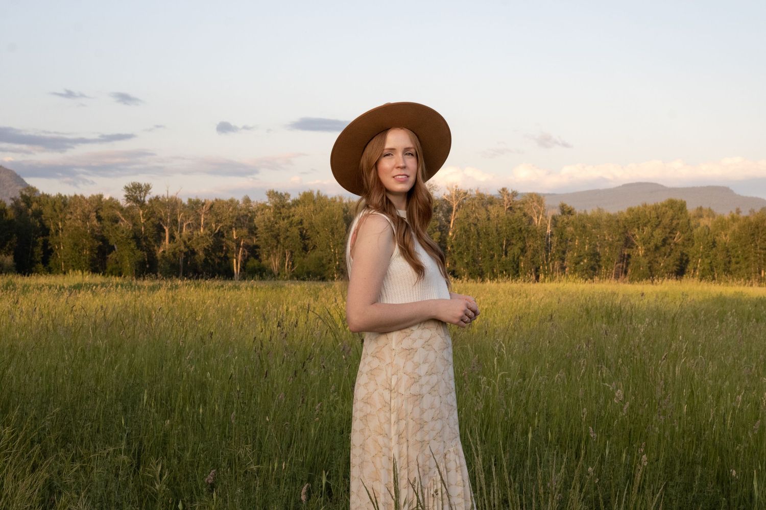 Sunset golden hour portrait in Kelowna with open field and stylish fashion photography