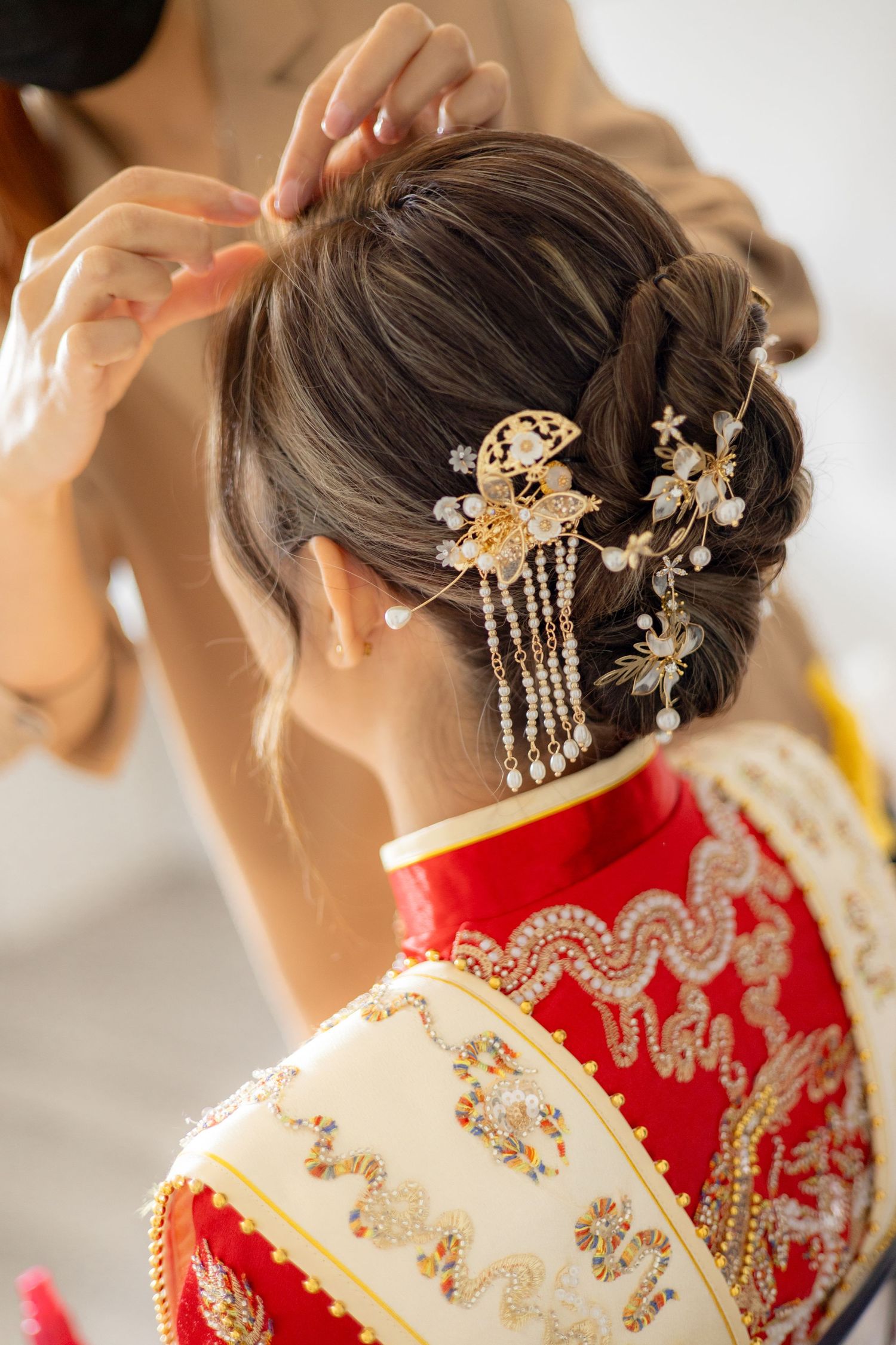 Ornate traditional Chinese bridal hair accessories with crystals and gold details.