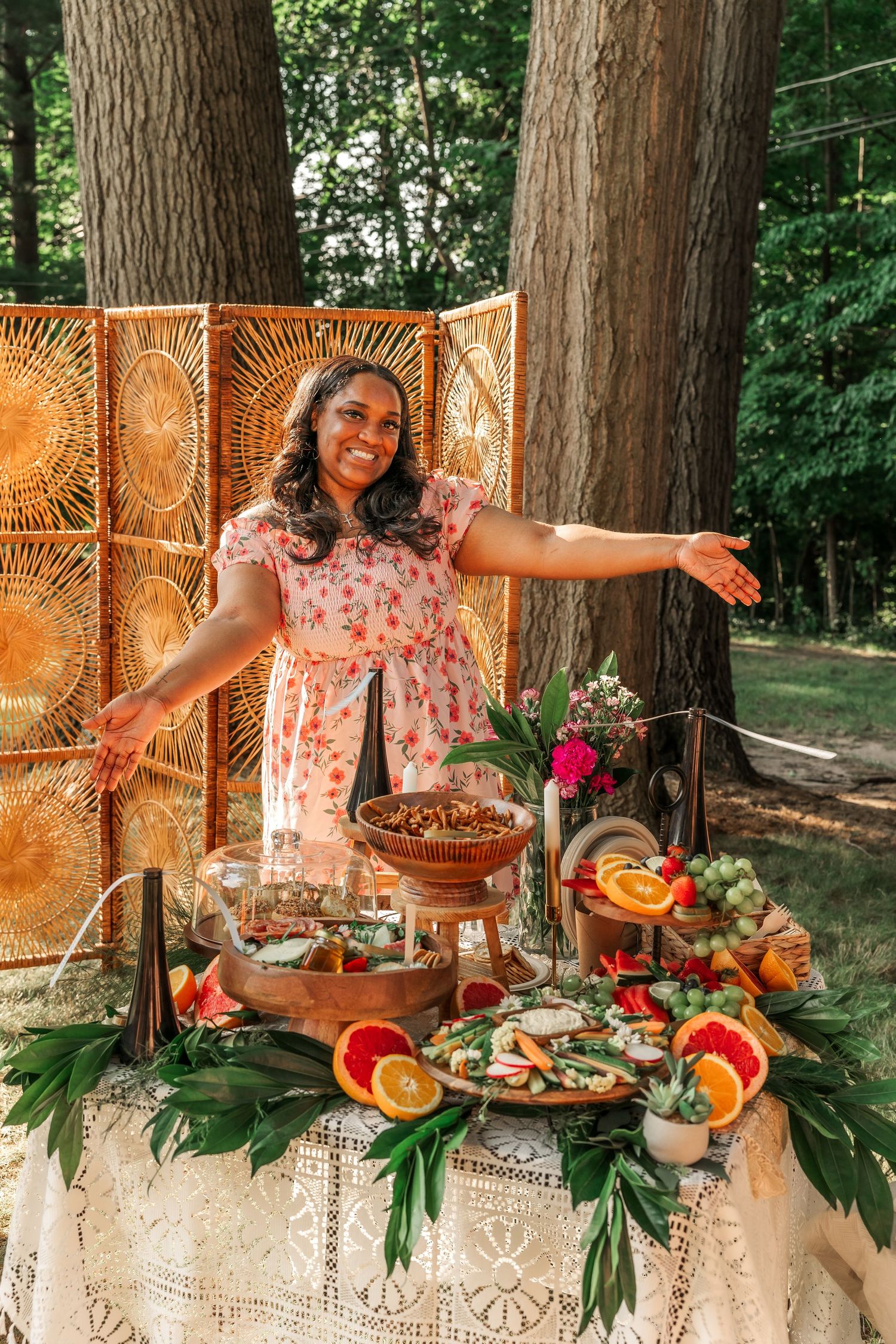 Tropical party spread with fruit and decorative elements on an outdoor table.