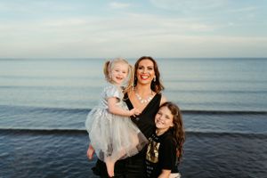A heartwarming family portrait by the ocean at sunset.