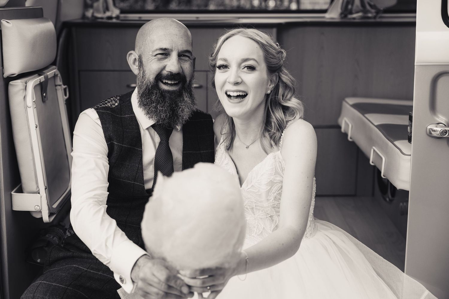 bride and groom laughing holding candy floss