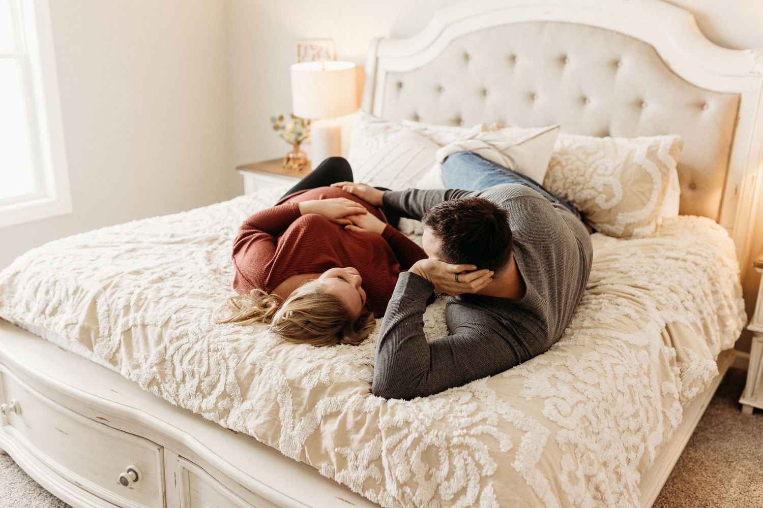 Lifestyle Maternity Photographer Fort Wayne Indiana in natural light in a bedroom with cream tones