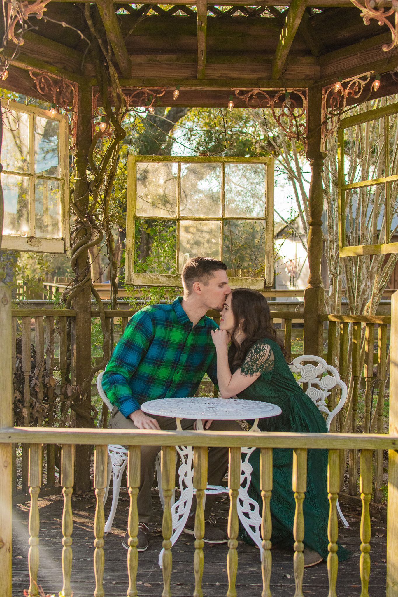 A romantic scene in a vintage gazebo with decorative metal furniture.