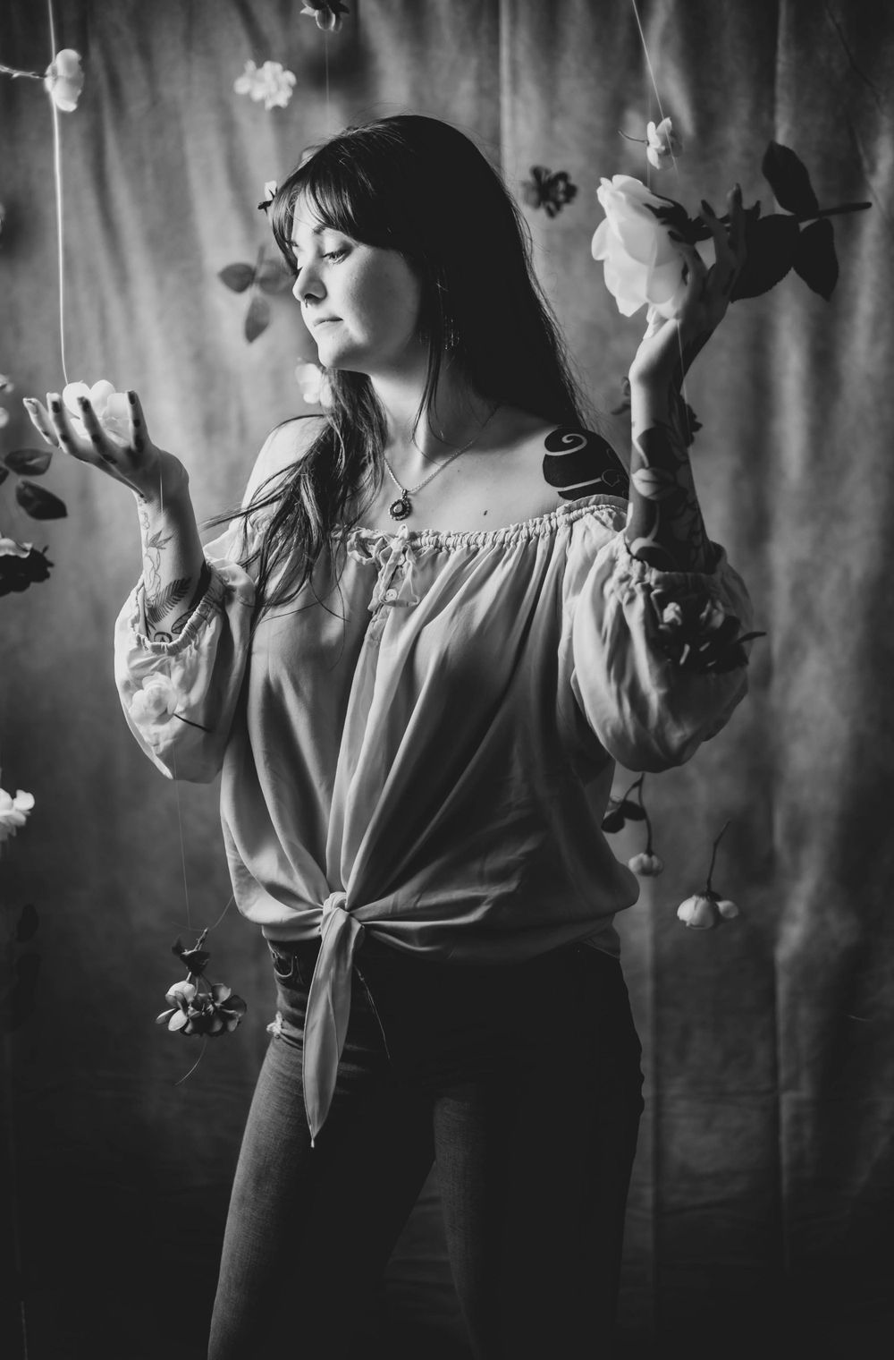 Black and white portrait series with vintage-style dress against dark backdrop.