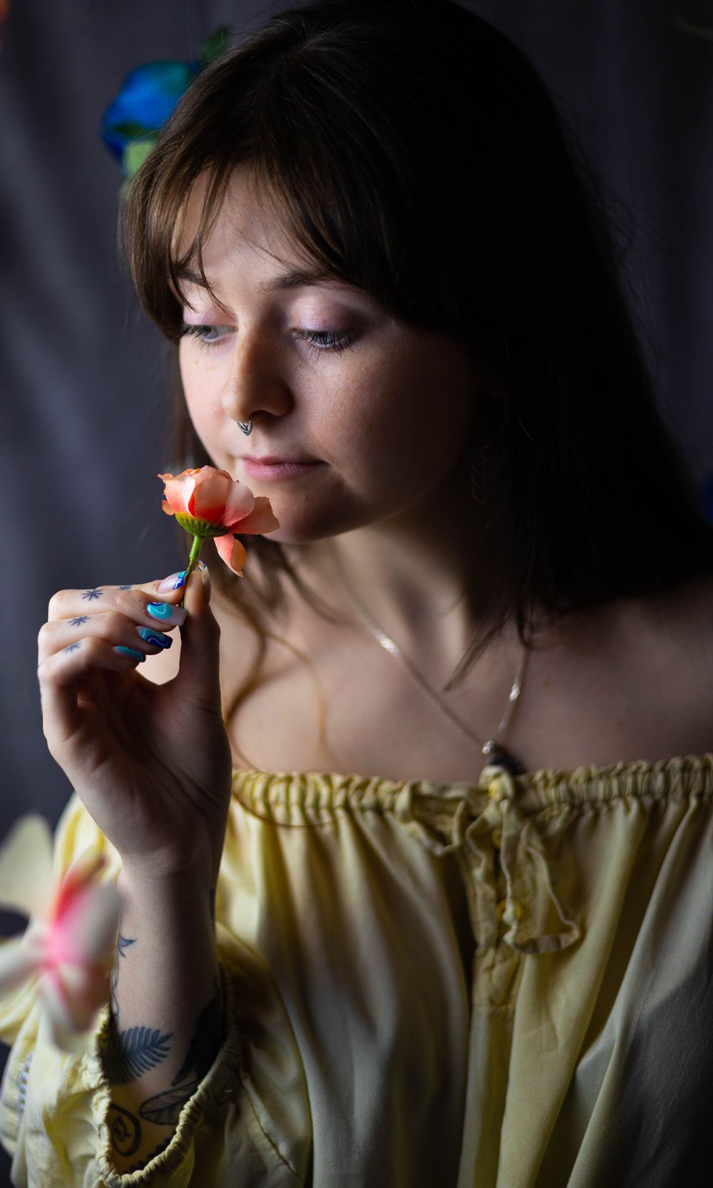 Artistic portrait series with soft lighting and delicate flower props.