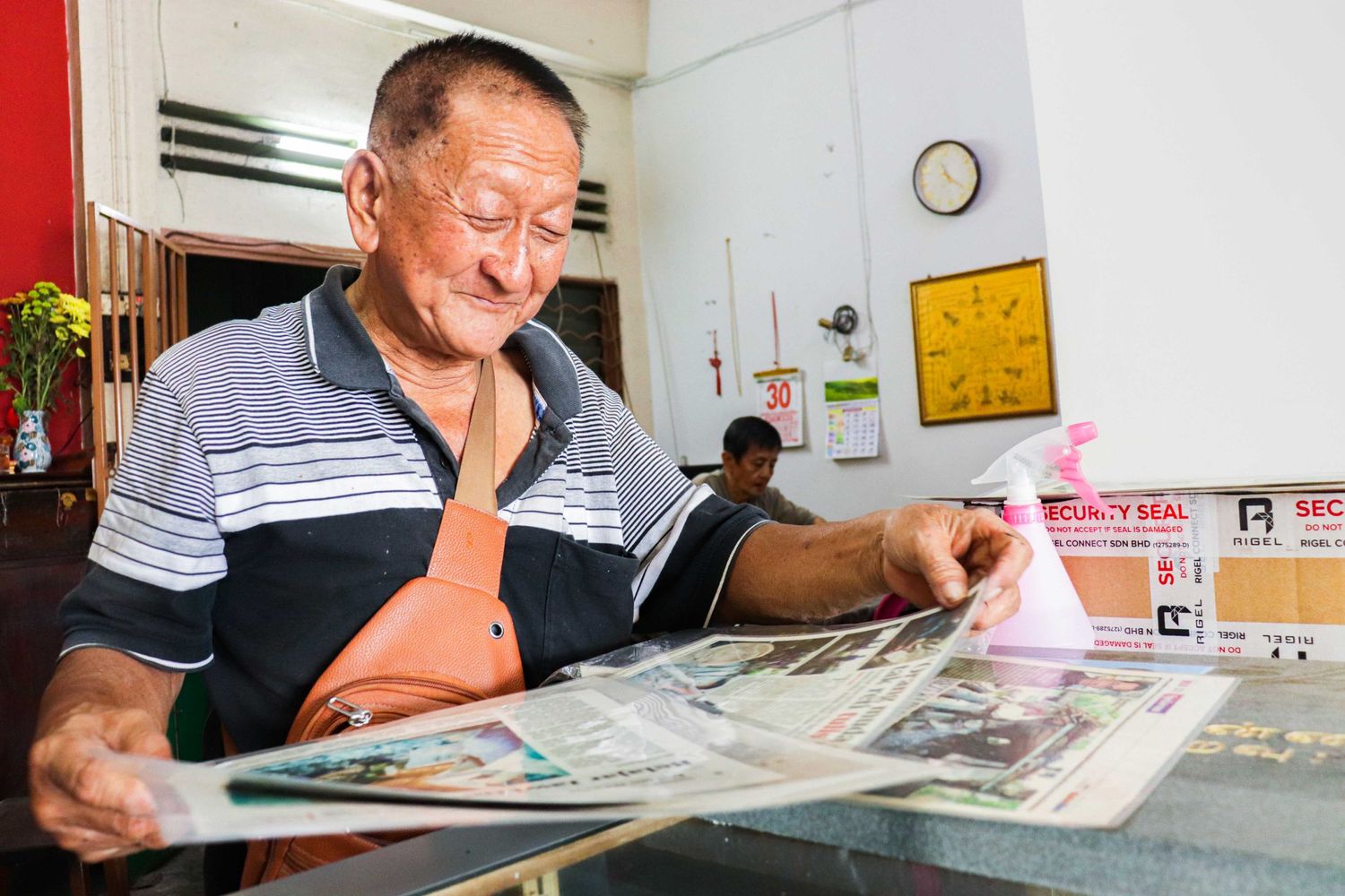 Mr. Kuah is reading one of the article that media had covered him