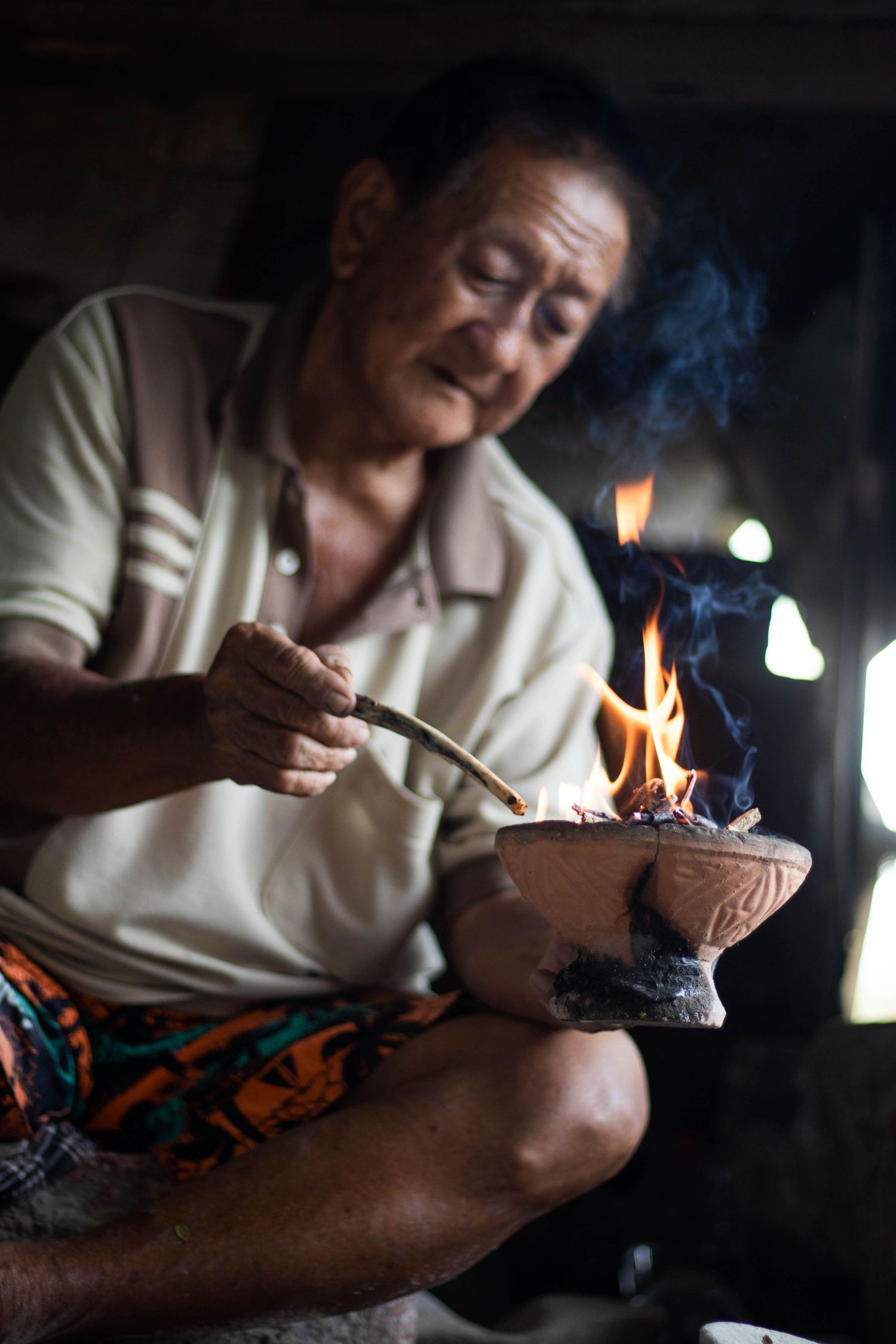 Mr. Kuah is burning incense for his prayer ceremony