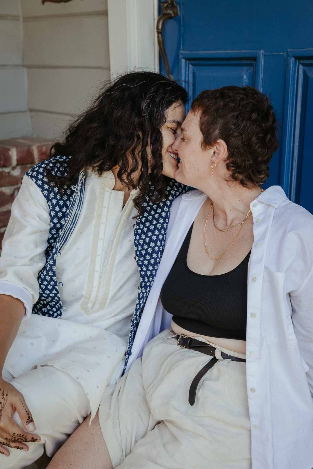 A tender romantic moment shared between a couple wearing white and polka dot outfits.