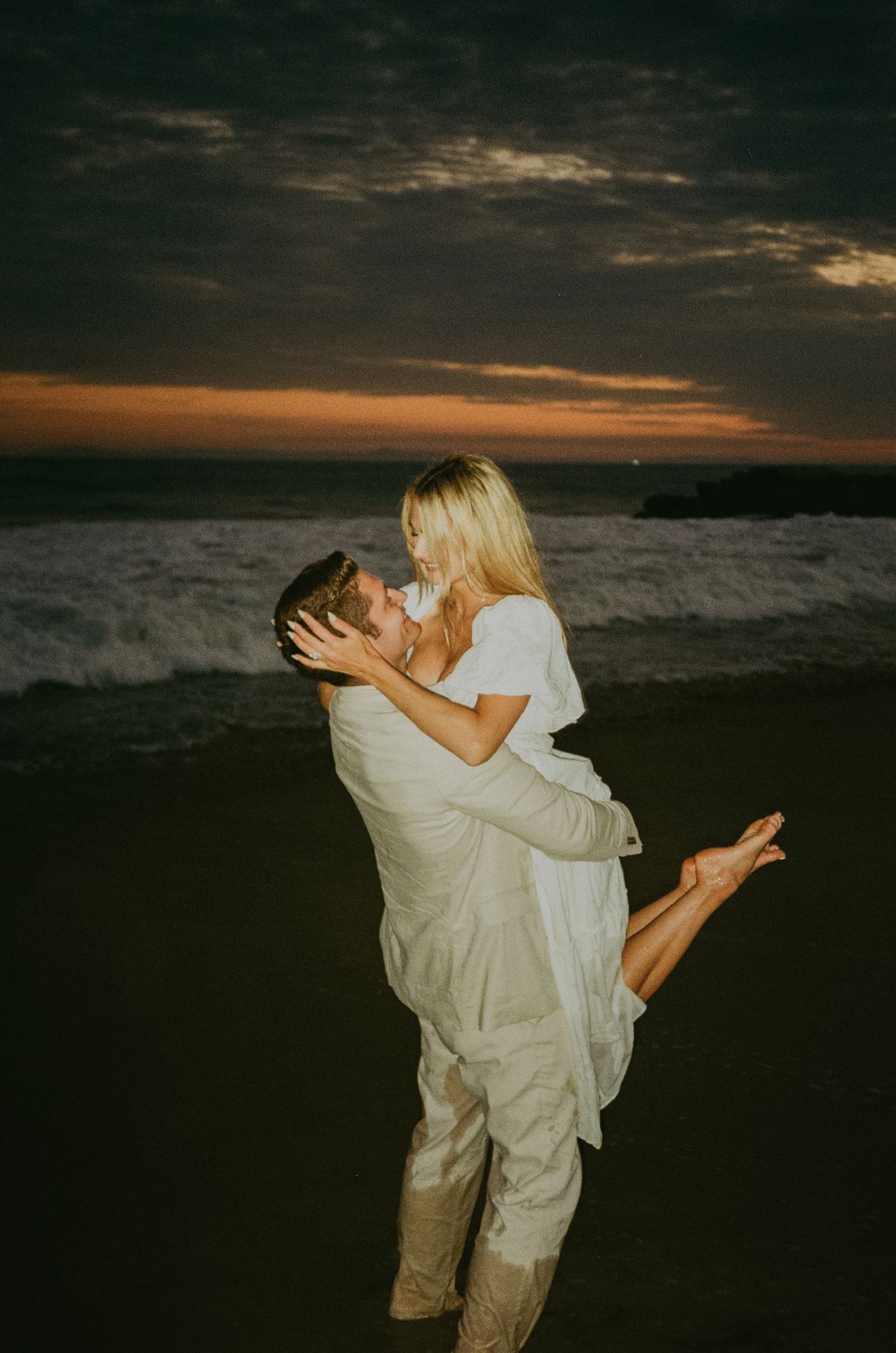 Newport beach sunset couple's engagement shoot on 35mm film camera during blue hour with flash