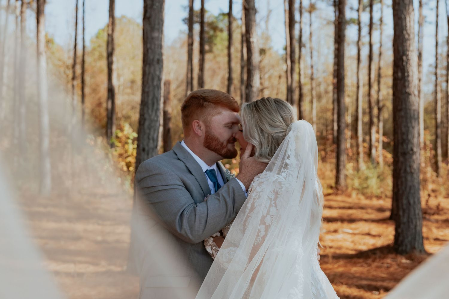 A romantic wedding photo session in a pine forest with soft natural lighting.