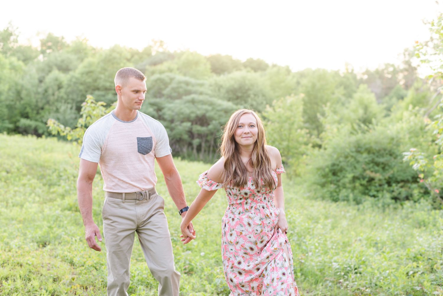 Couple walking in field for engagement in St. Mary's Pennsylvania