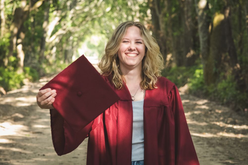A series of five photos showing someone in a burgundy graduation gown posing outdoors in a wooded setting.