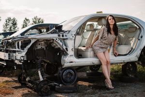 Stylish portrait session incorporating deconstructed vehicles and industrial elements.