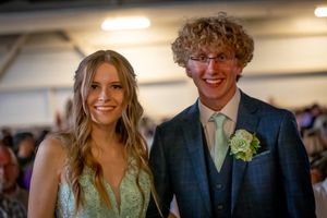 Formal couple at prom or special event in evening attire.