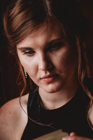 Moody portrait in warm tones featuring soft lighting and vintage-inspired styling.